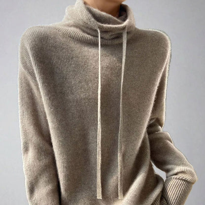 Mujer con jersey holgado de cuello alto y cordón ajustable en tono khaki