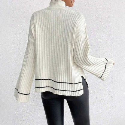 Mujer luciendo el jersey NÓRDICA de cuello alto combinado con pantalón de piel